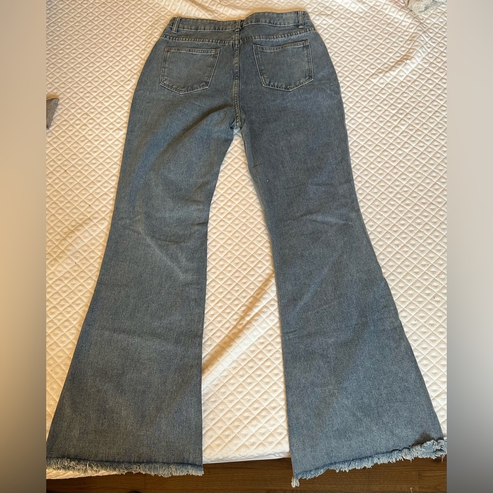 Brand NEW high waisted flair distressed never worn blue jeans